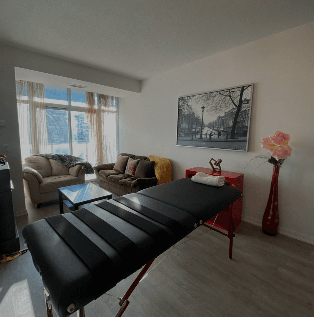 Fascial Stretch Therapy treatment room with massage table and fitness equipment