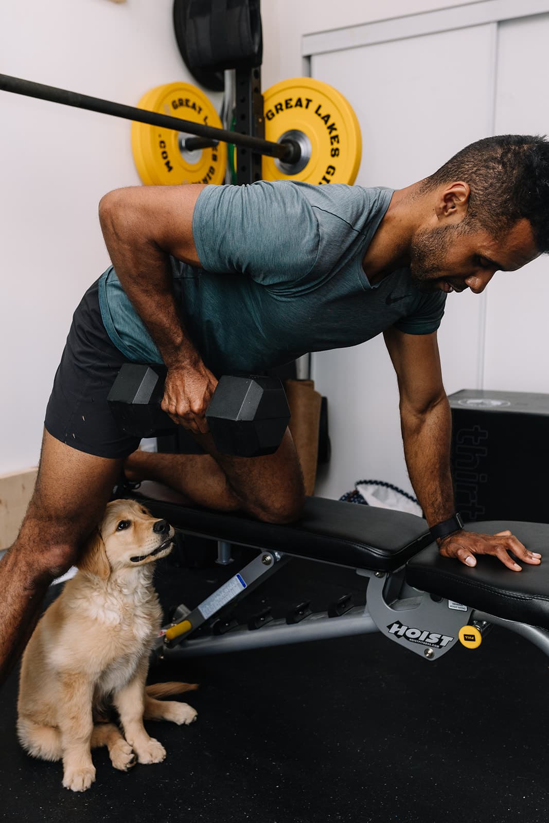 Sean Beckford dumbbell row with puppy